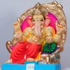 Ganesh idol sitting on simhasan with Mukut.